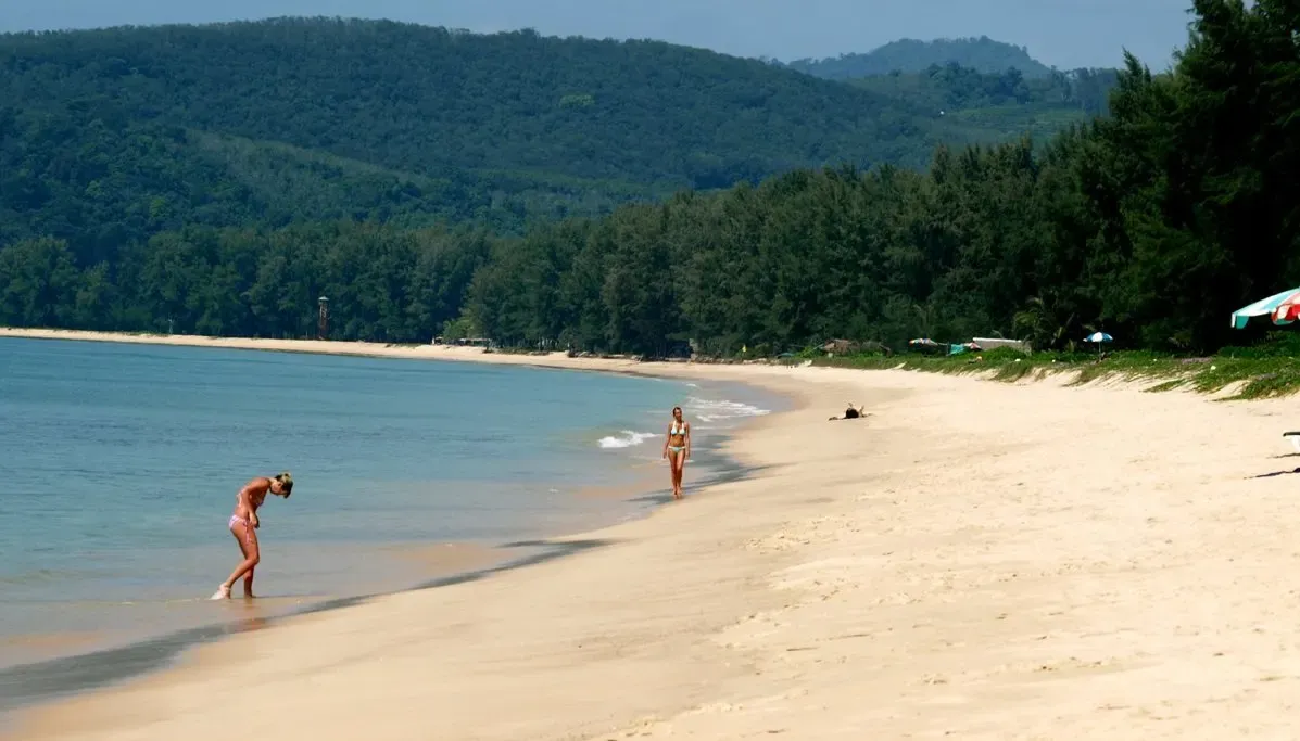 Bang Tao Beach in Phuket with soft sand and forested headlands