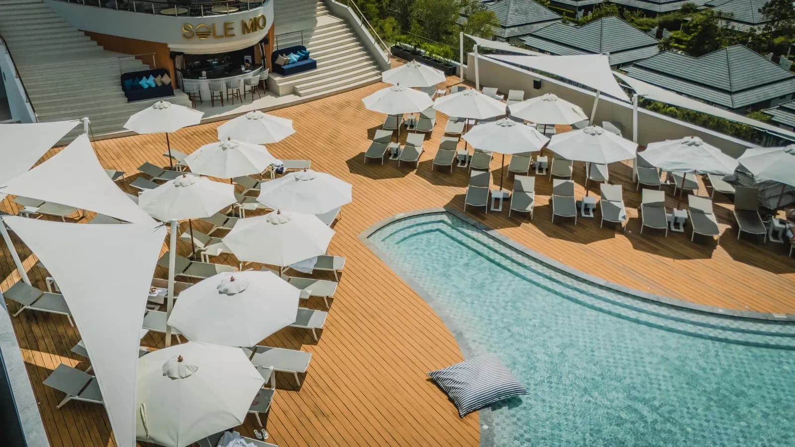 The Sole Mio Boutique Hotel pool deck with loungers and shade sails in Phuket