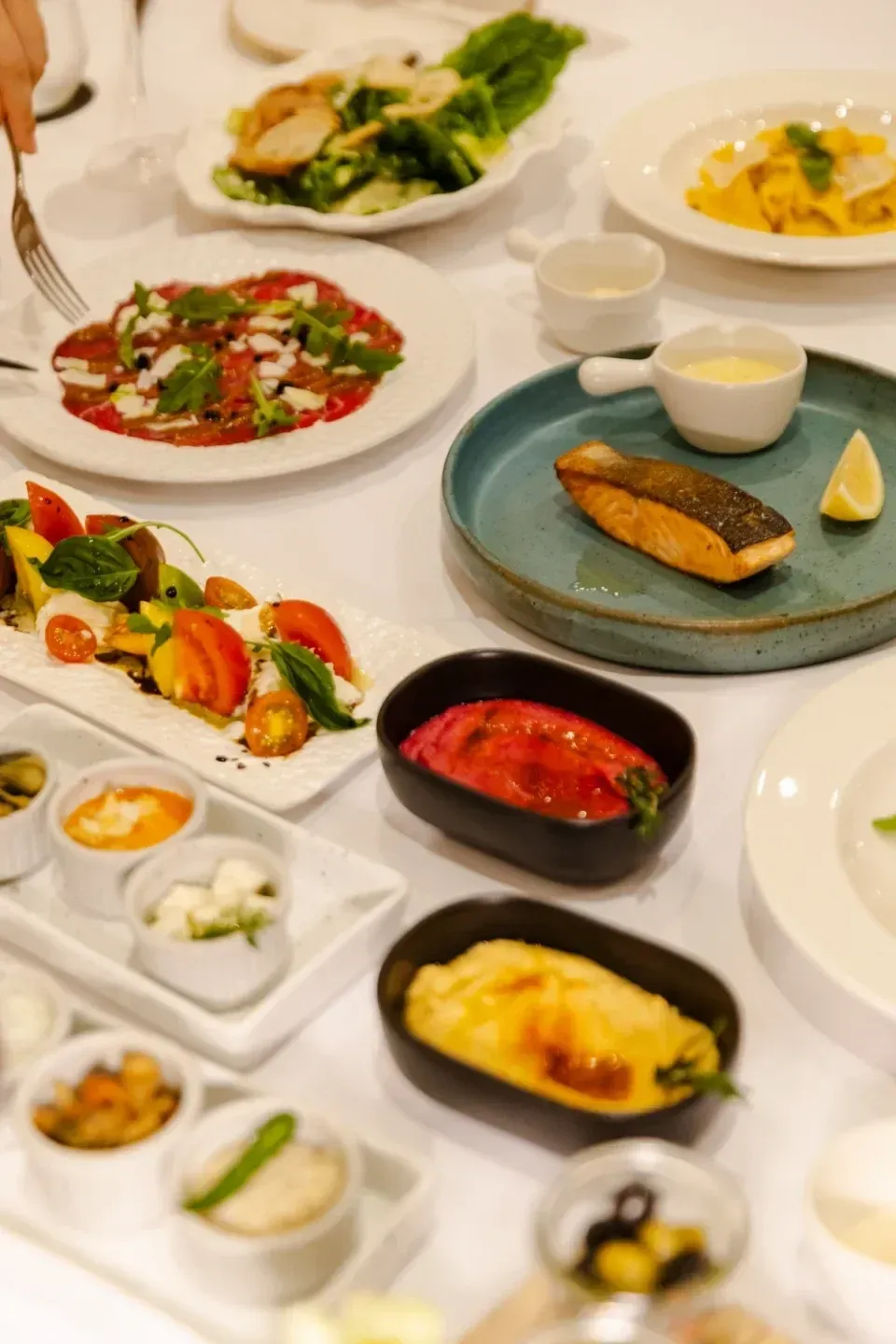 A full-board dinner spread of fresh Mediterranean and Thai dishes at Sole Mio