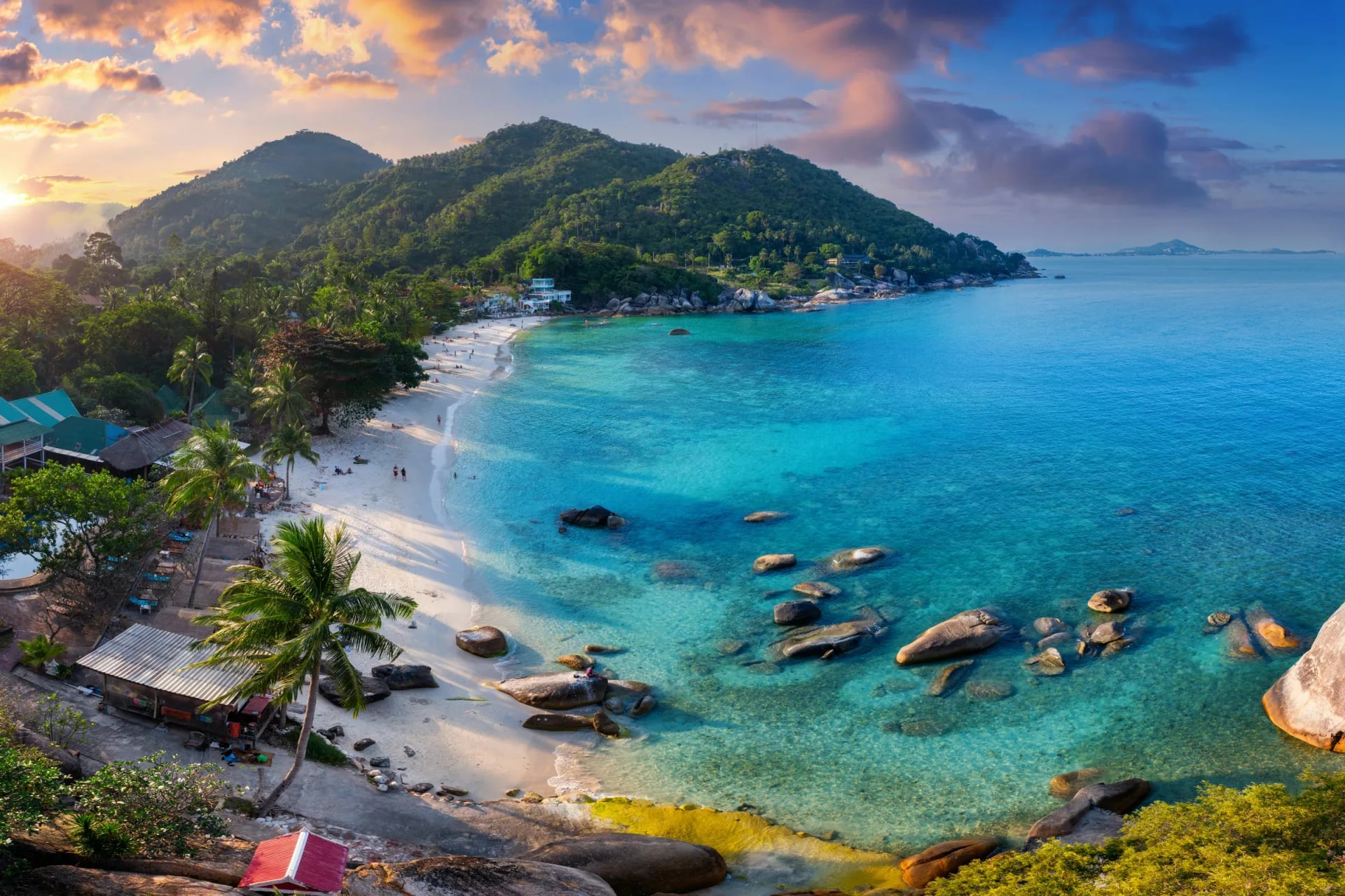 Thailand island coastline with clear water and tropical hills