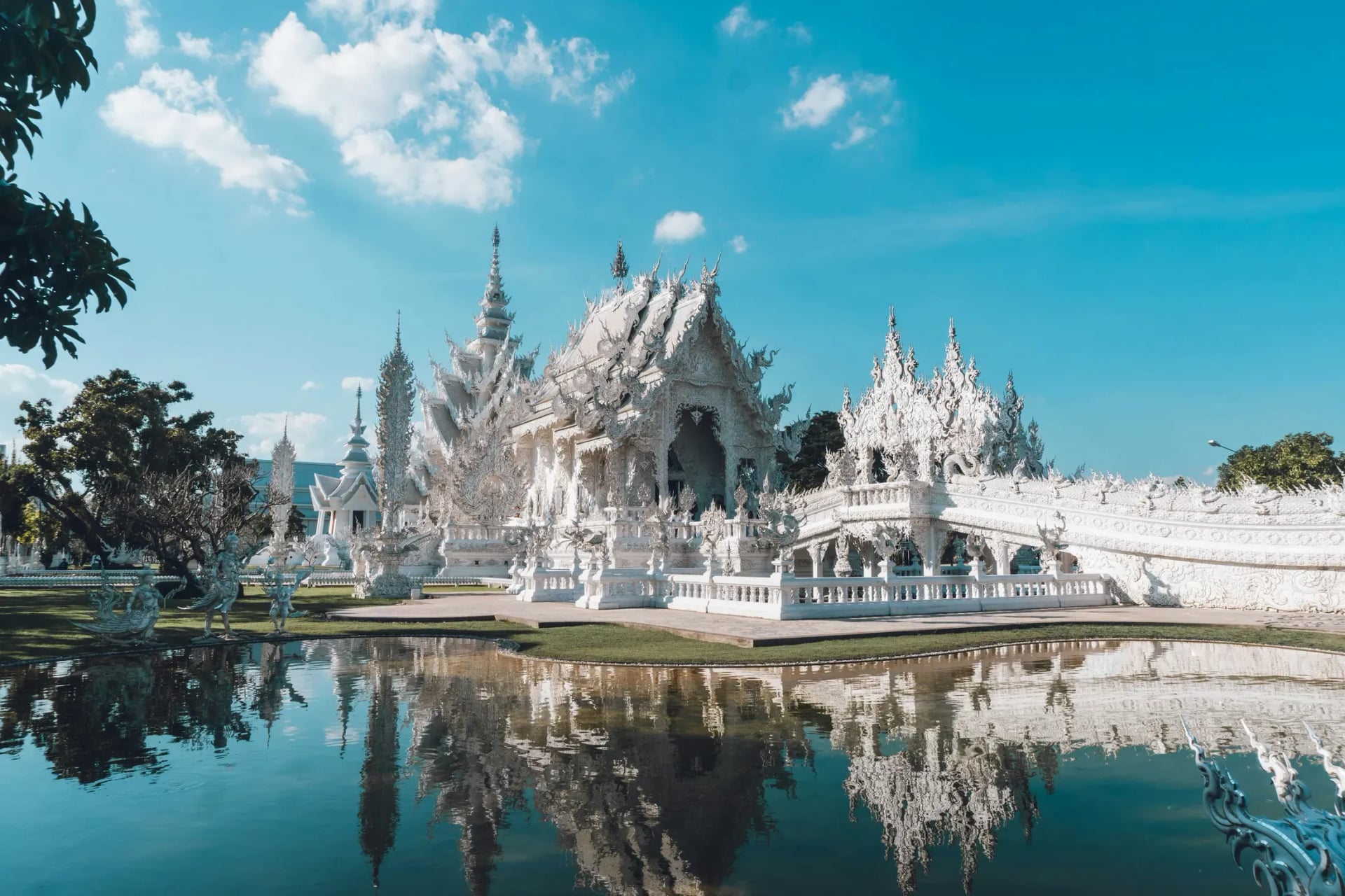 White Temple Wat Rong Khun reflected in water in Chiang Rai