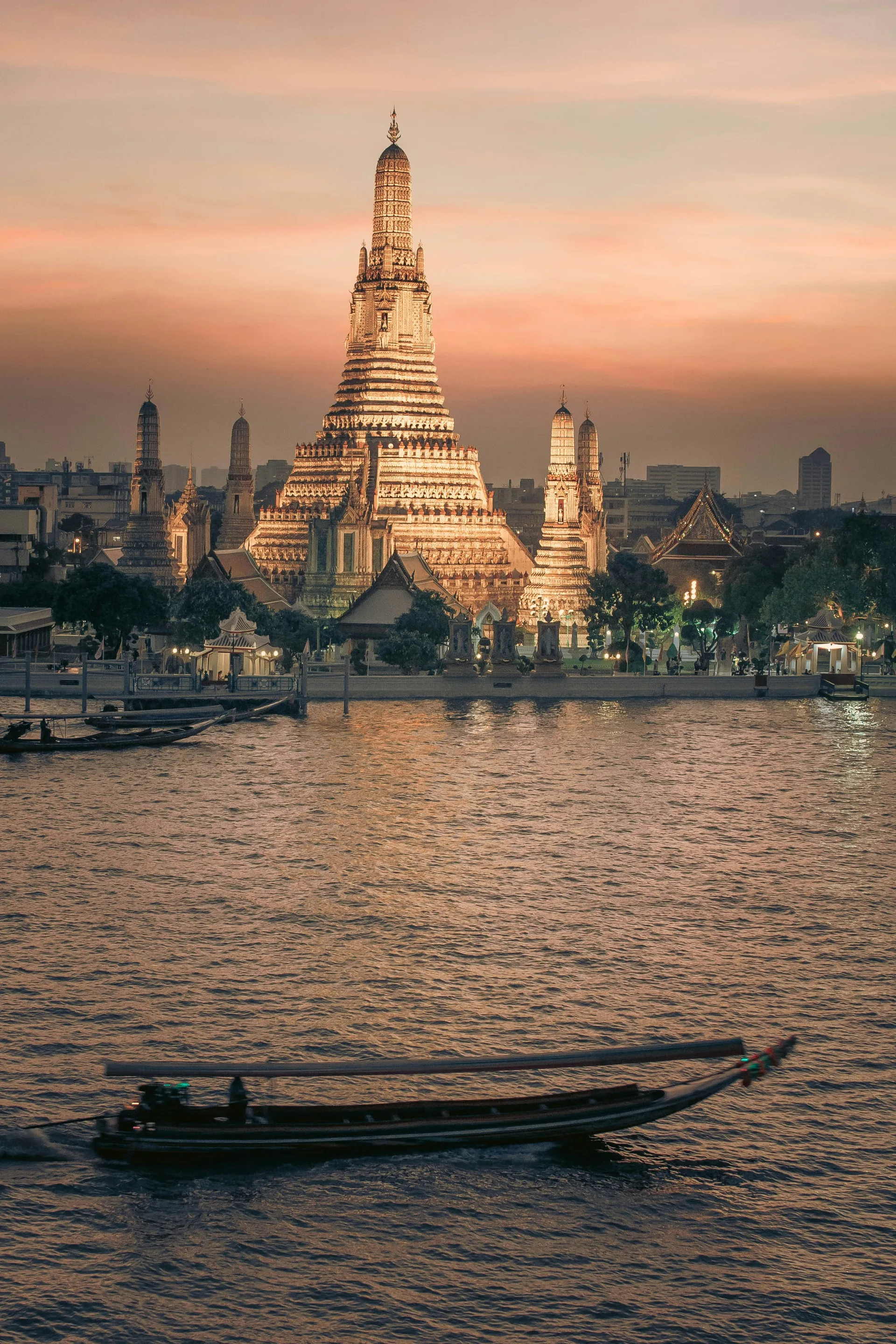 Wat Arun temple beside the Chao Phraya River in Bangkok at sunset