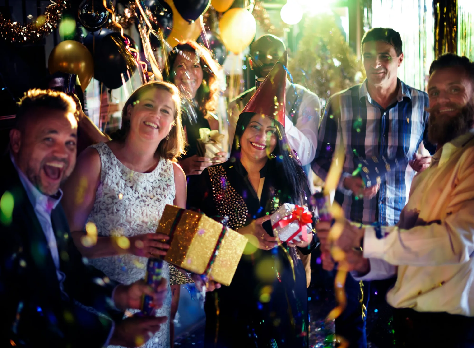 Group celebration with confetti and party gifts