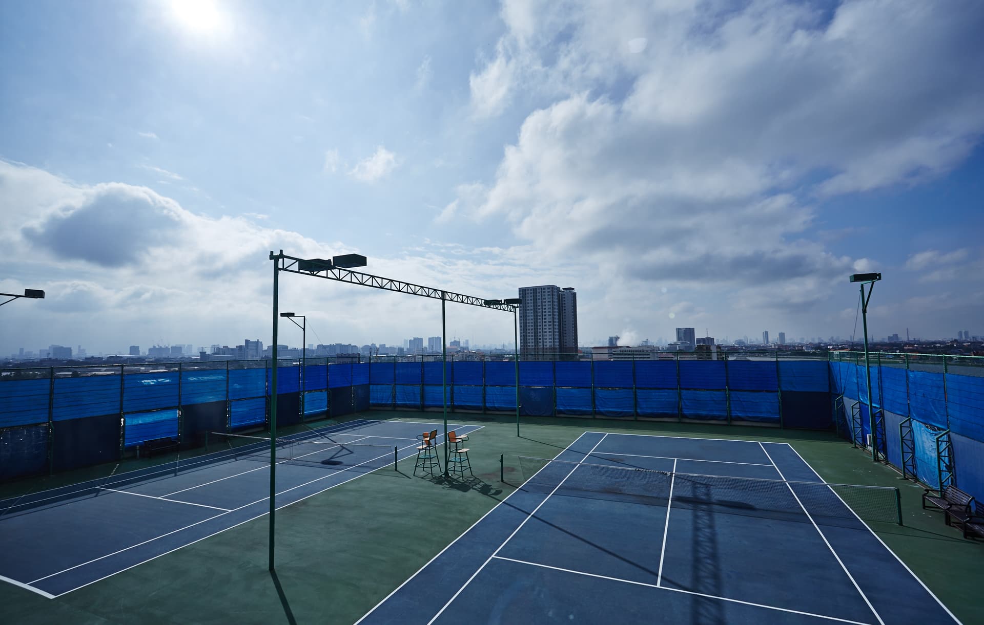 Rooftop tennis court with panoramic Bangkok city view