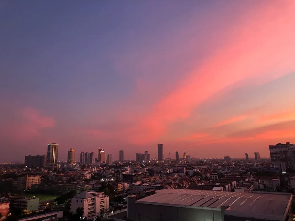 Bangkok city skyline at sunset viewed from a rooftop